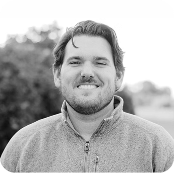 ADN team member headshot, black and white outdoor portrait